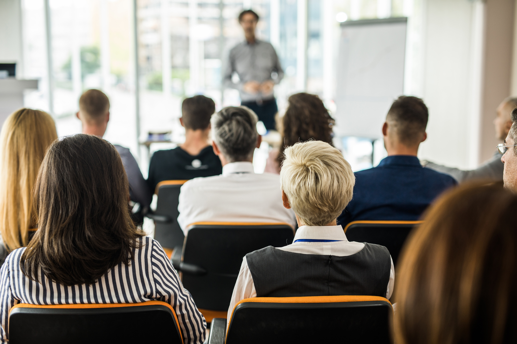 Rear view of entrepreneurs attending a business seminar in board room.