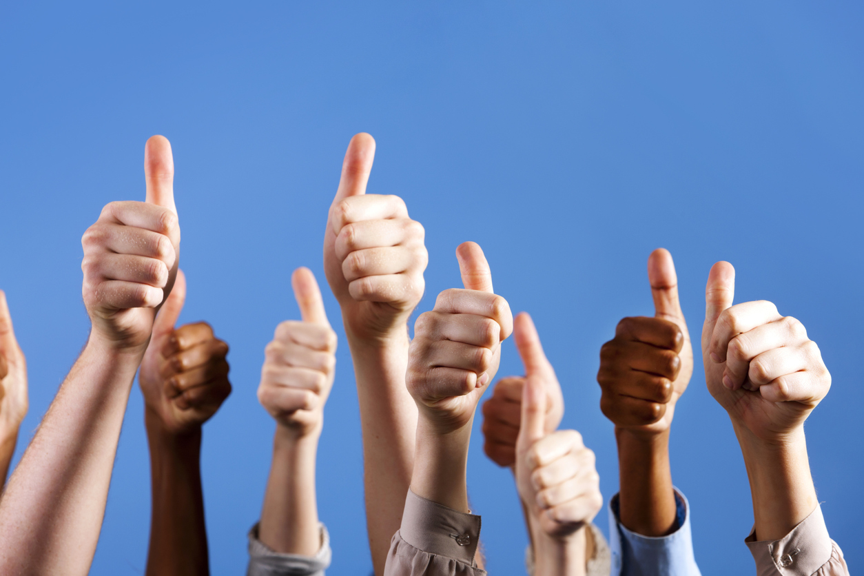 Many multiracial hands give group thumbs up of approval